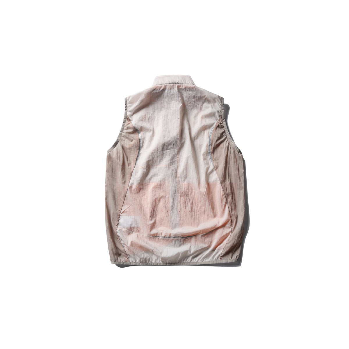 Back view of a pale blush sleeveless vest with curved side panels and a curved seam near the hem.