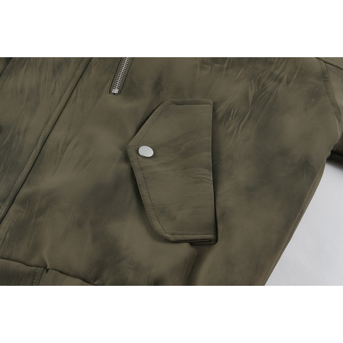 Close-up of an olive-brown jacket pocket flap with a snap, beside a vertical zipper.