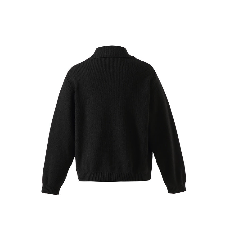 Back view of a plain black long-sleeve sweater with a raised collar and ribbed cuffs and hem.