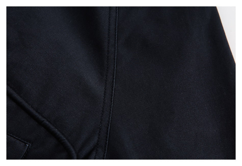 Close-up of the dark navy jacket fabric and a stitched seam.