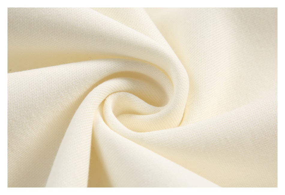 Close-up of cream-colored fabric gathered into a spiral fold.