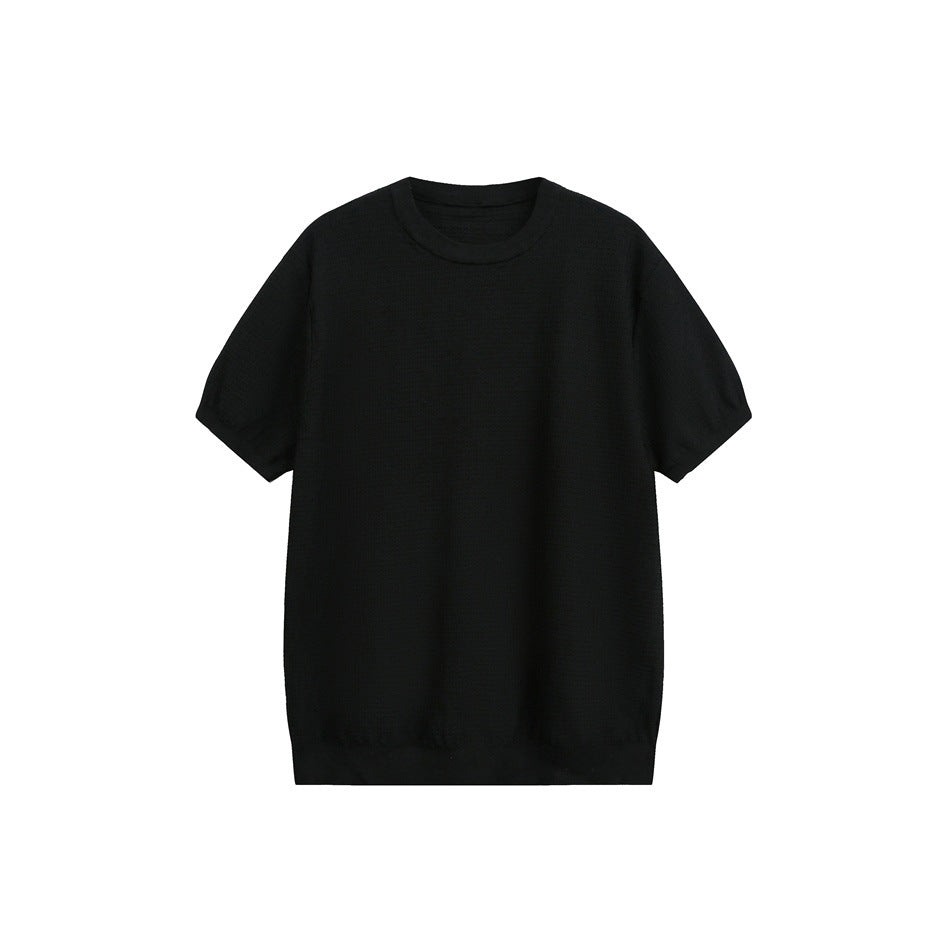 Black short-sleeve crew neck top with waffle-grid knit texture and ribbed trim, flat front view