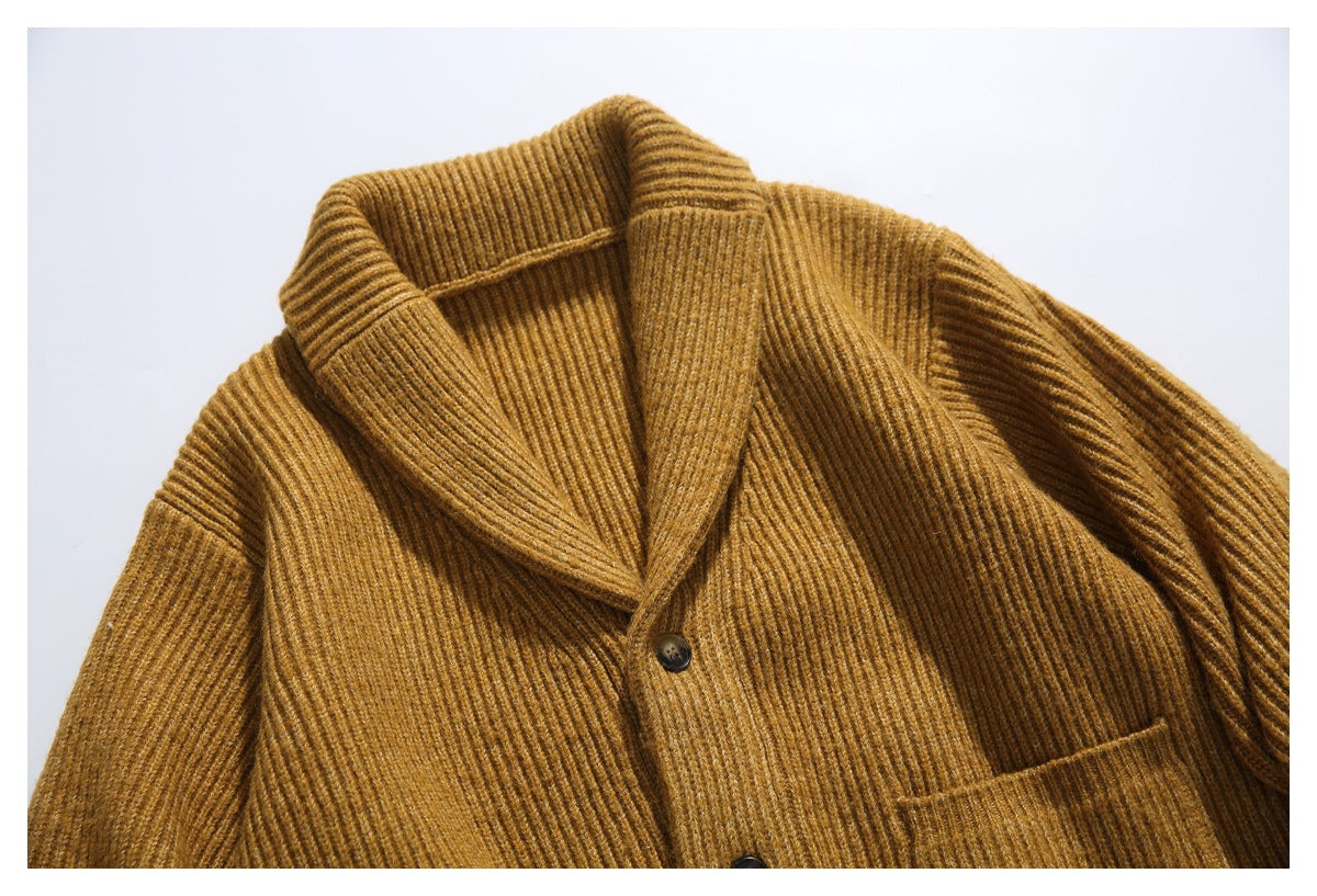 Close-up of a mustard-brown ribbed cardigan showing its shawl collar and dark front buttons.