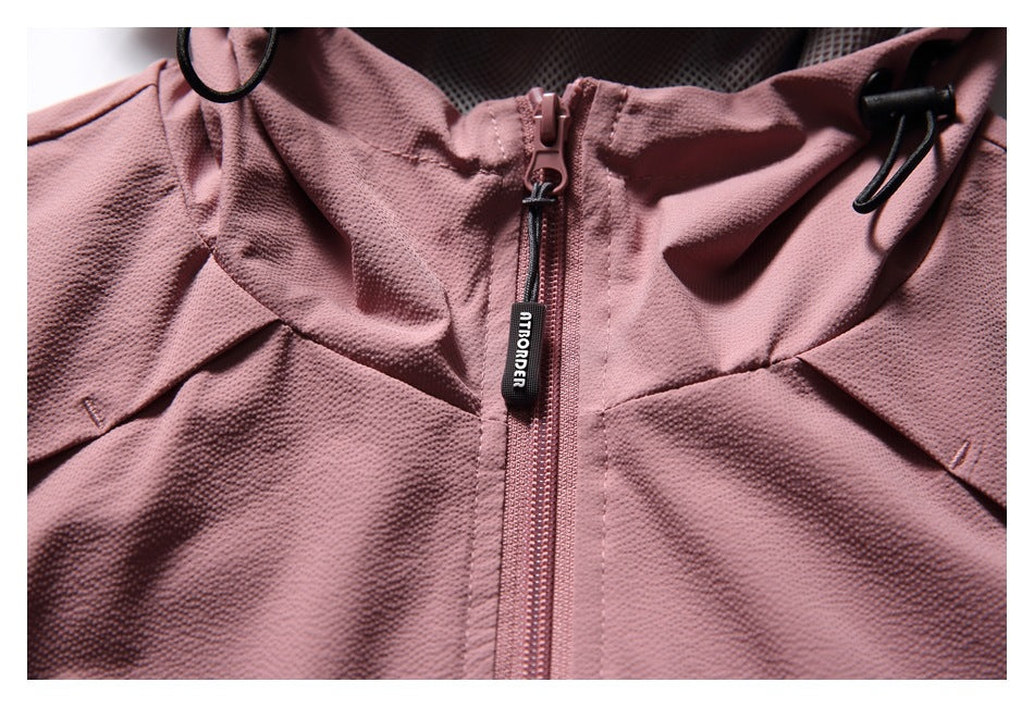 Detail of the dusty rose hood and center zipper, with black drawcord toggles and a branded zipper pull.
