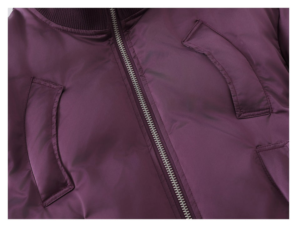Close-up of the jacket's silver zipper and several stitched front pockets.