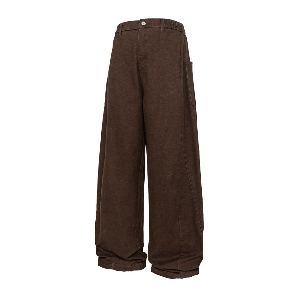 Brown wide-leg pants with elastic waistband, button fly, large side pocket and curved leg seams