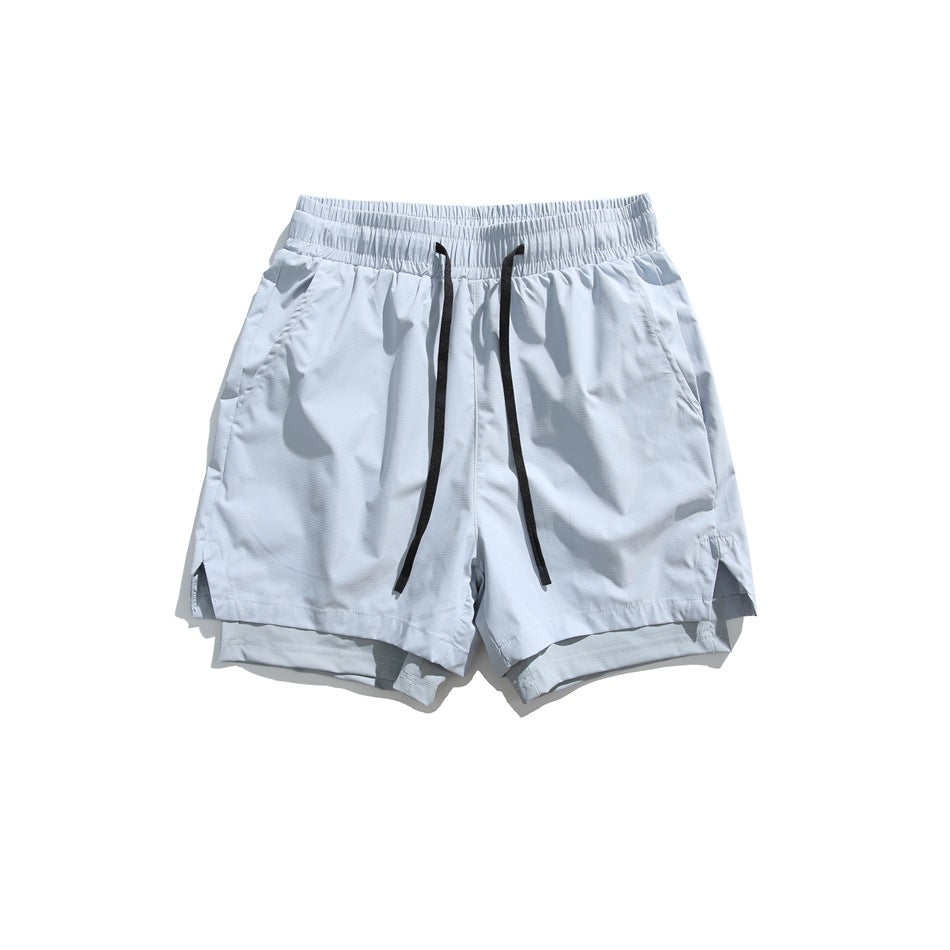 Light blue drawstring shorts flat lay, front view, with black cord, side pockets and layered hem