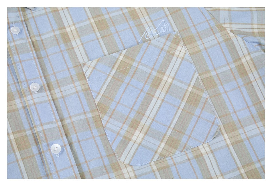 Close-up of the shirt's plaid chest pocket and white embroidered script.