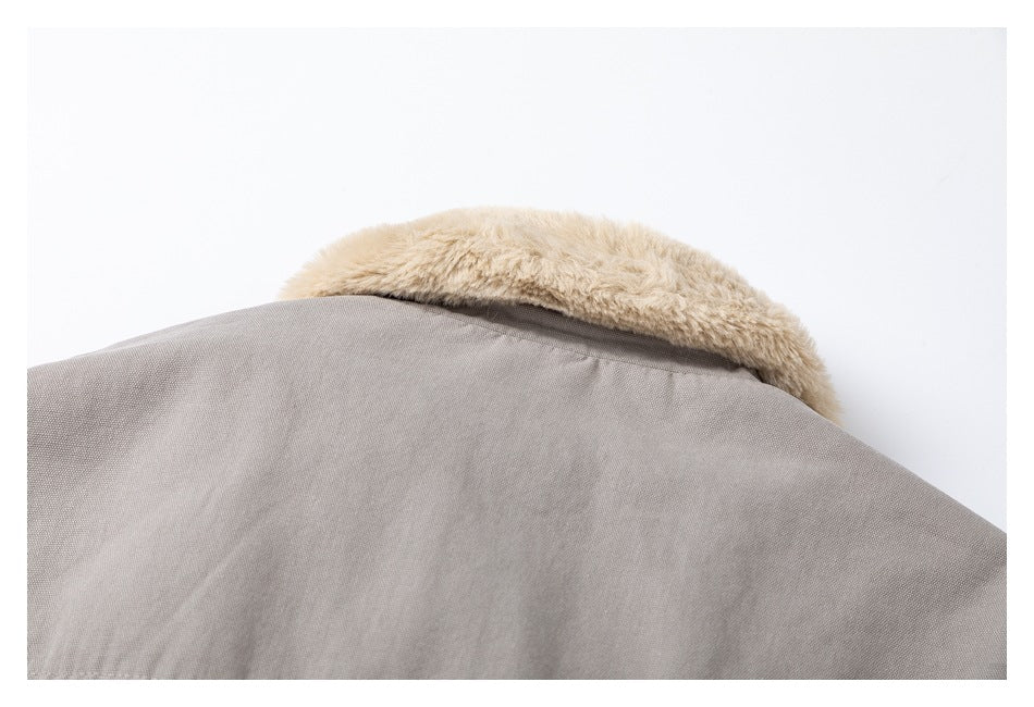 Close-up of the back of a light taupe jacket with a beige faux-fur collar.