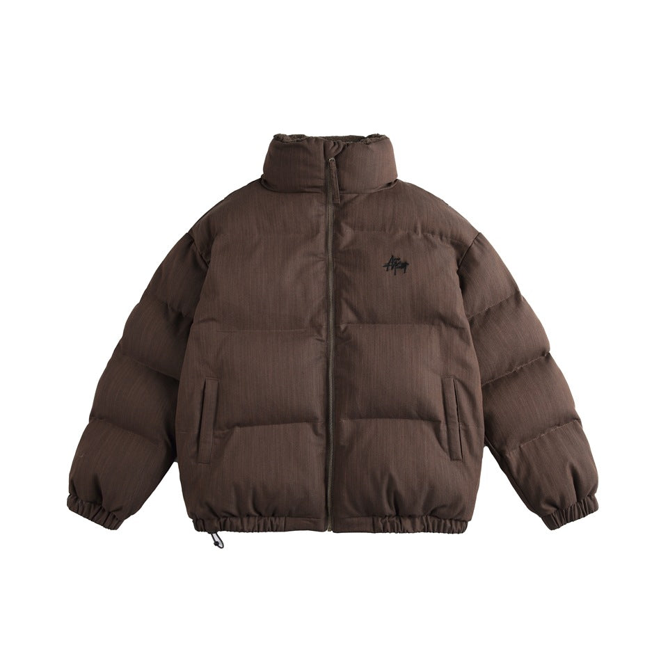 Denim brown puffer-style jacket with stand collar, front zip, slanted pockets, elastic cuffs and chest embroidery, front view