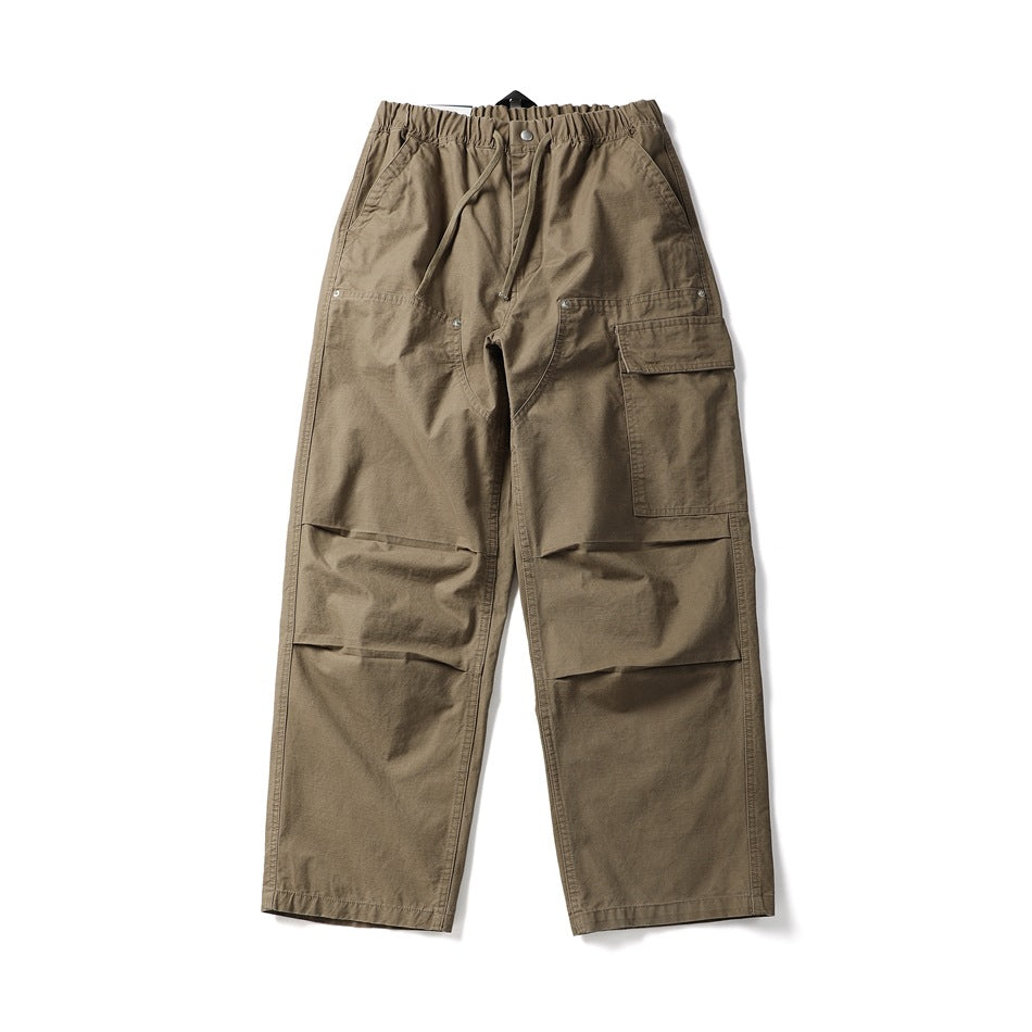 Khaki wide-leg cargo pants with drawstring elastic waist, side cargo flap pocket and knee pleats, flat lay front view