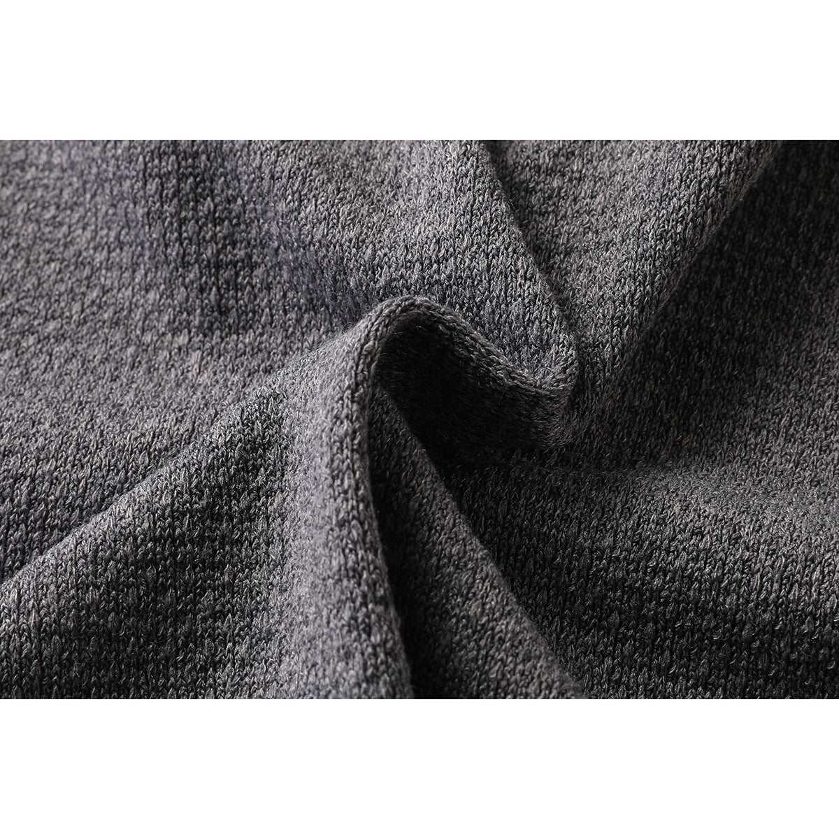 Close-up of the charcoal gray top's textured knit fabric, shown gathered in folds.