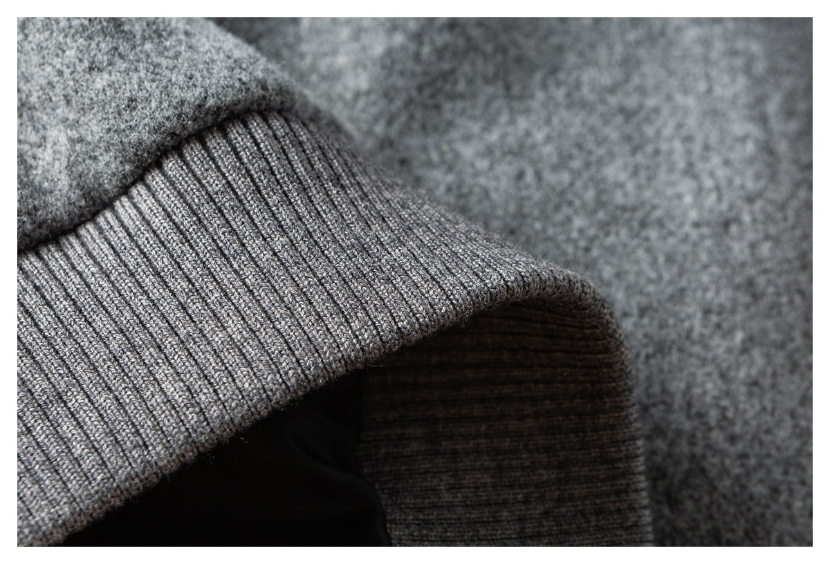 Close-up of a gray rib-knit cuff attached to mottled gray fabric.