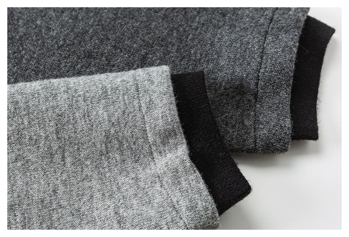 Close-up of heather gray knit garment edges layered with black trim.