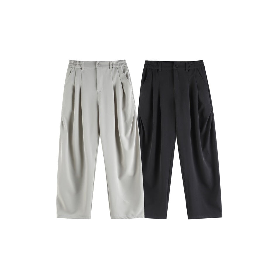 Front view of pleated, wide-leg trousers in light gray and black, shown side by side.