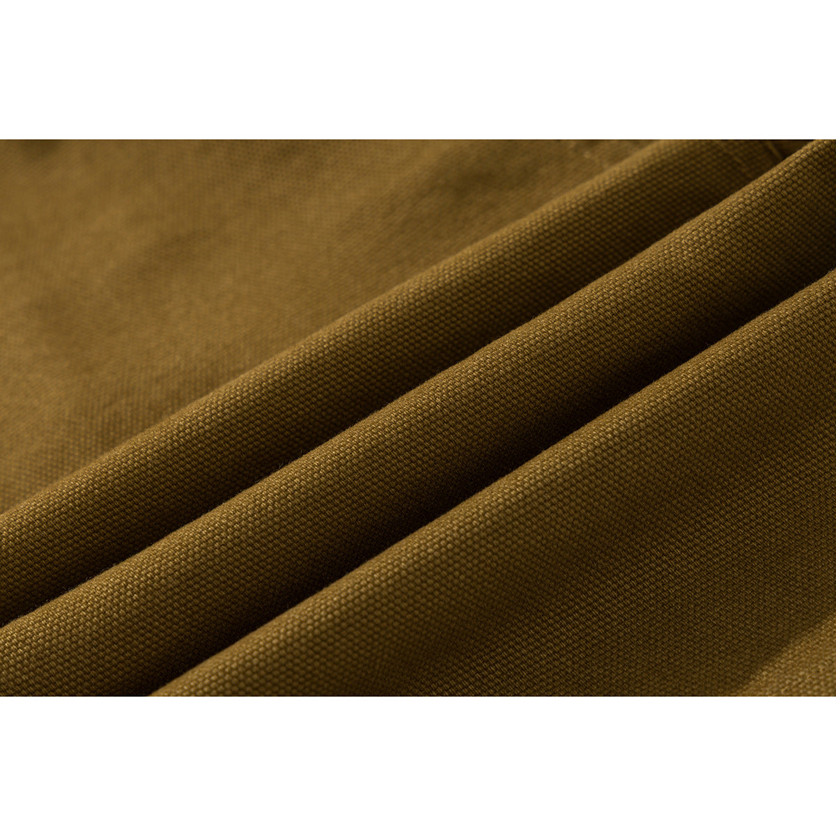 Close-up of the textured mustard-brown fabric arranged in soft folds.