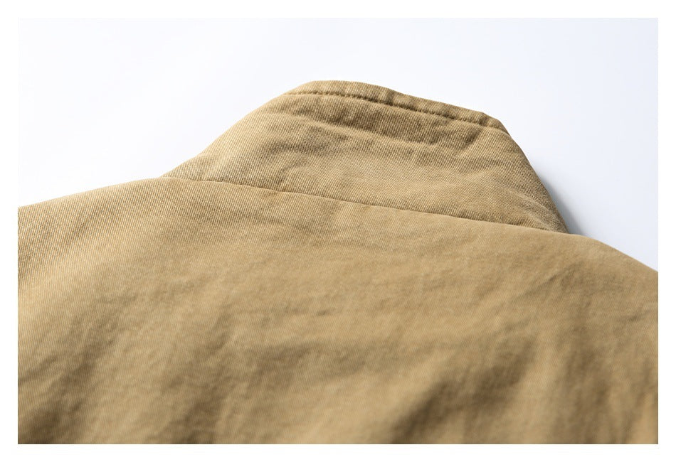 Close-up of the tan-brown garment's collar and upper back seam.