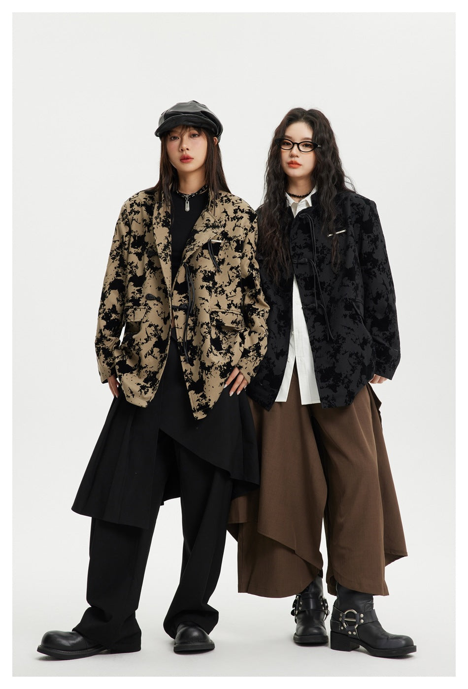 Two models show the printed jacket in taupe and black colorways, styled with loose layered outfits.