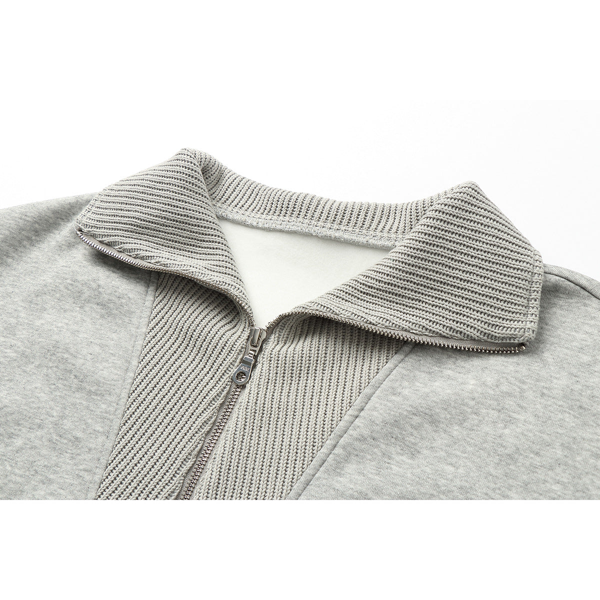 Close-up of a light gray zip-up jacket showing its wide ribbed collar and upper front.