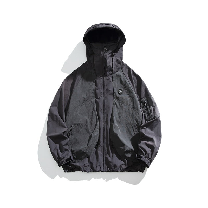 Gray hooded zip-up lightweight jacket flat lay with chest patch and sleeve pocket