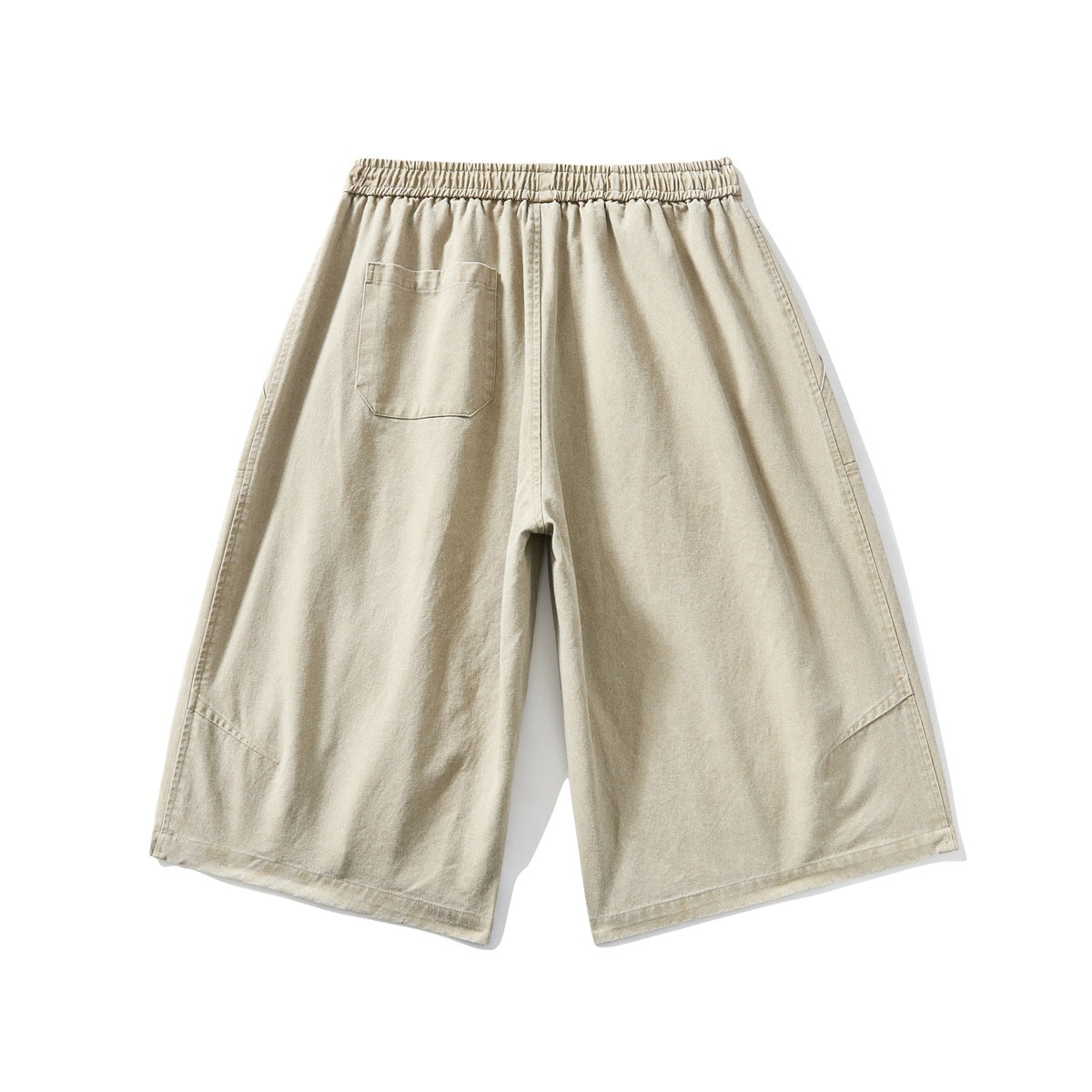 Back view of beige wide-leg shorts with an elastic waistband and a single patch pocket.