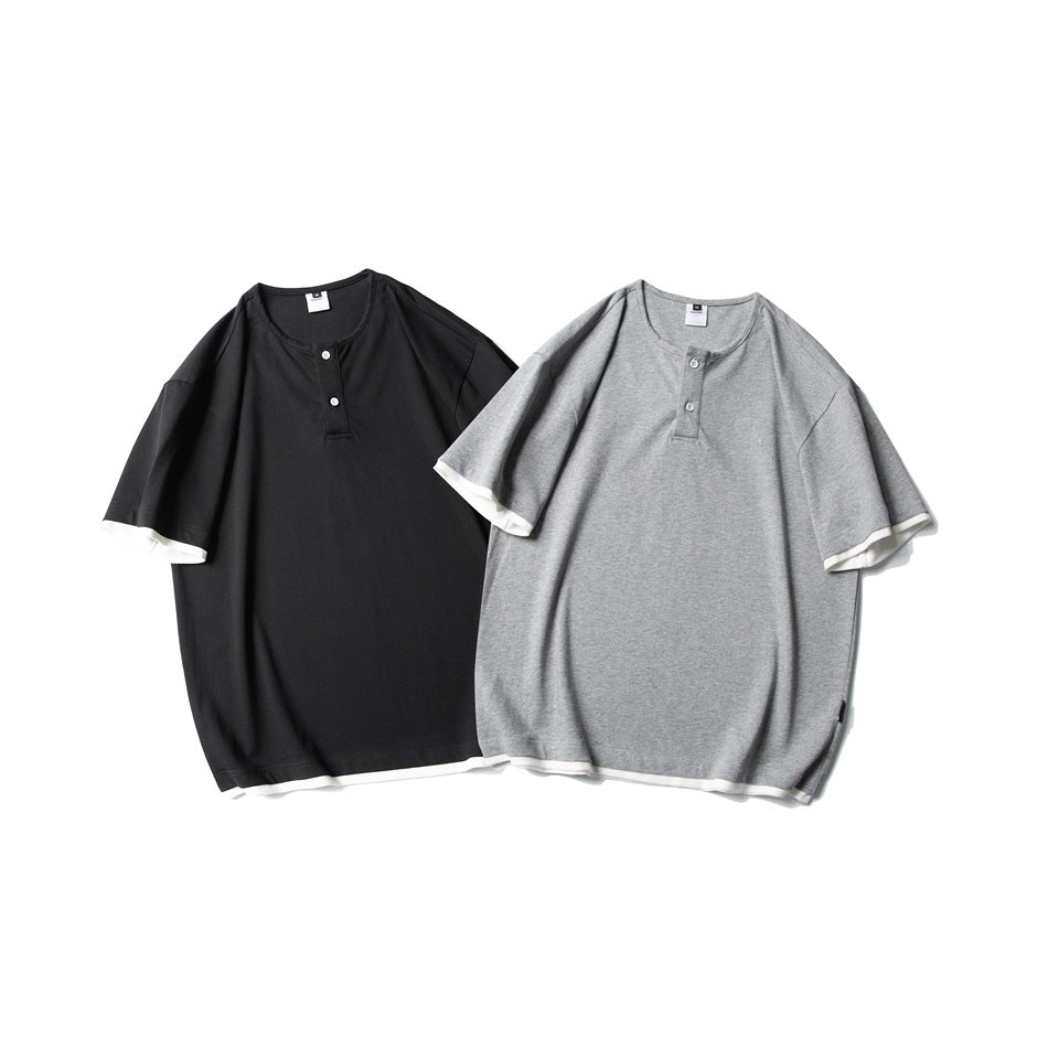 Two oversized short-sleeve henley shirts shown from the front in black and heather gray, both with white trim.