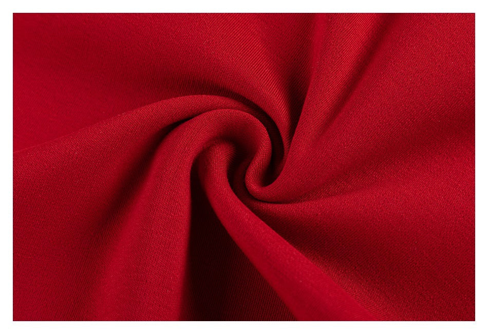 Extreme close-up of red garment fabric folded into a swirl.