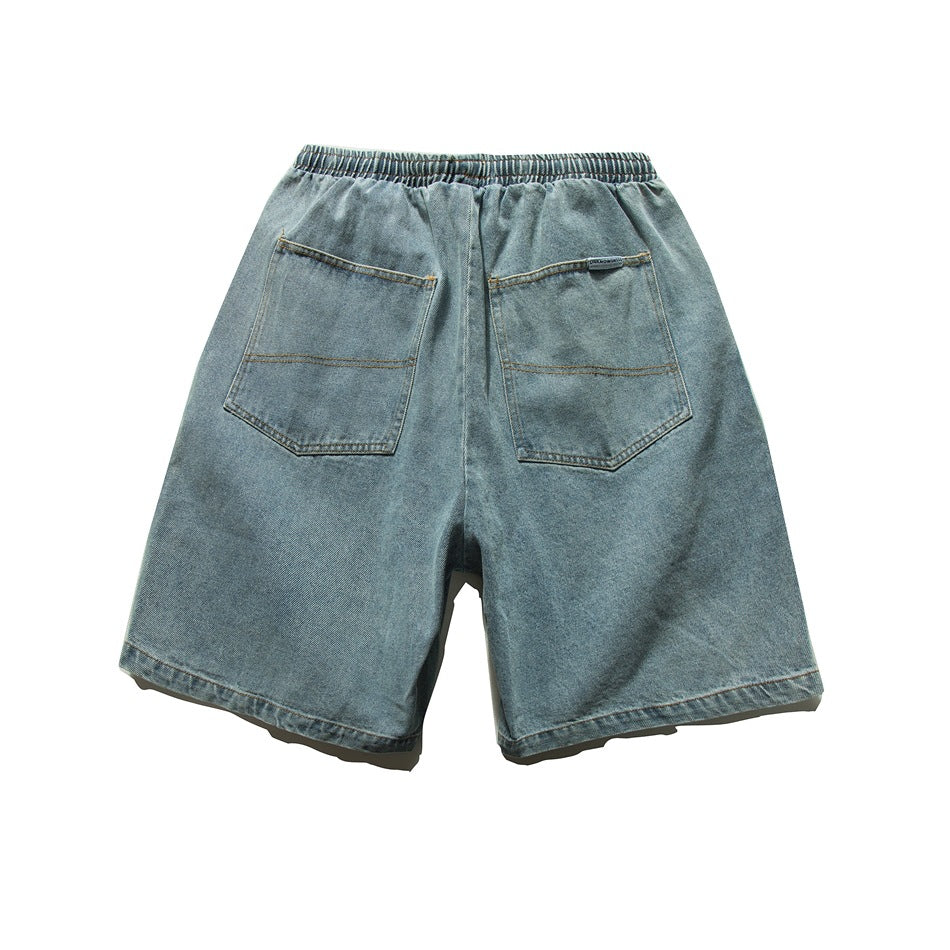 Light blue washed denim shorts back view with elastic waistband and two patch back pockets