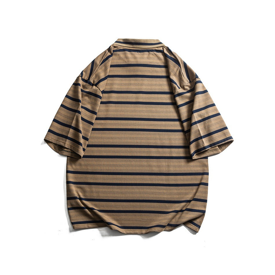 Back view of a tan and navy striped oversized collared T-shirt laid flat on a white background.