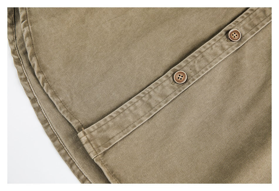 Close-up of a tan shirt placket with two brown buttons and parallel stitching.