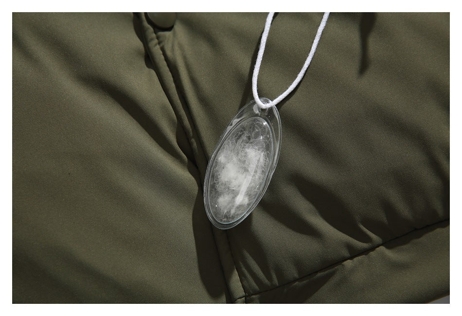 Close-up of an olive-green padded garment with a clear oval tag on a white cord.