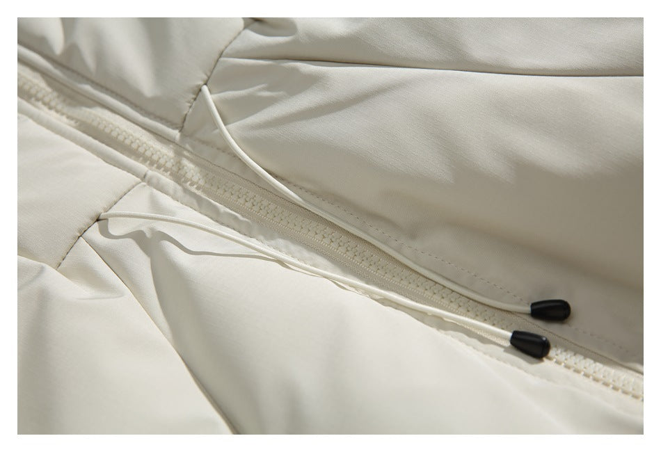 Close-up of an off-white jacket zipper and two drawcords with black toggles.