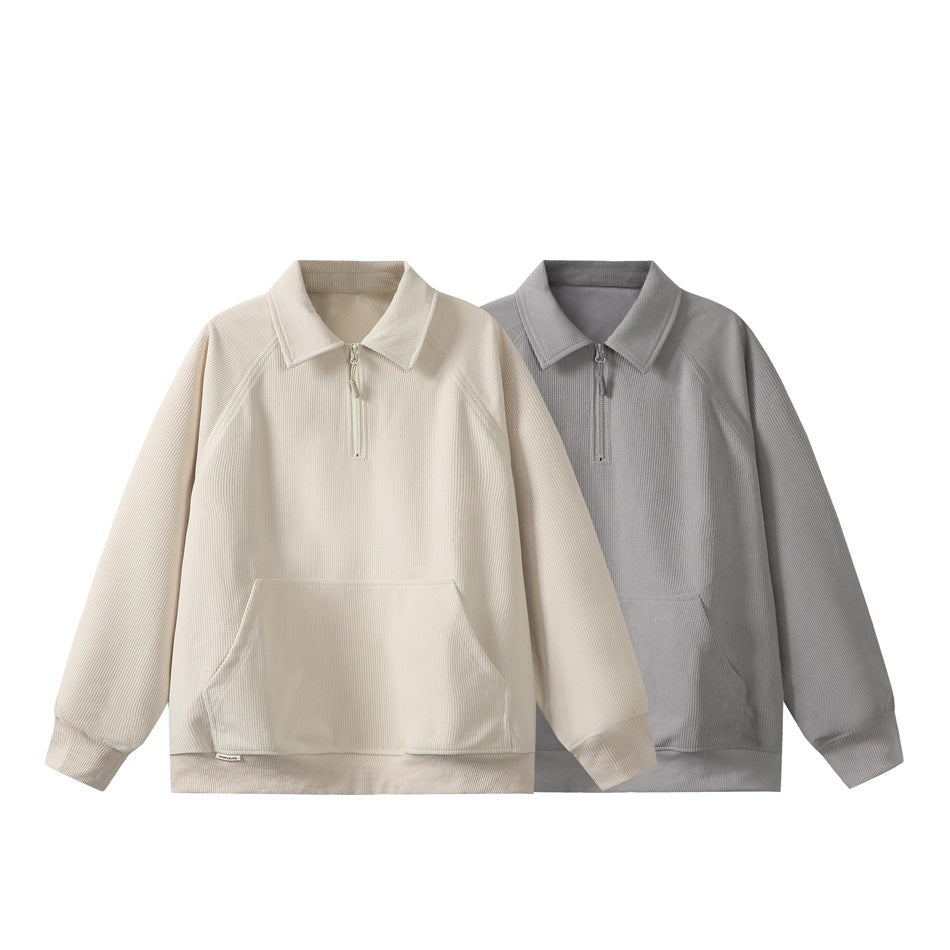 Cream and gray long-sleeve pullovers with collars, short zippers, kangaroo pockets, and ribbed cuffs and hems.