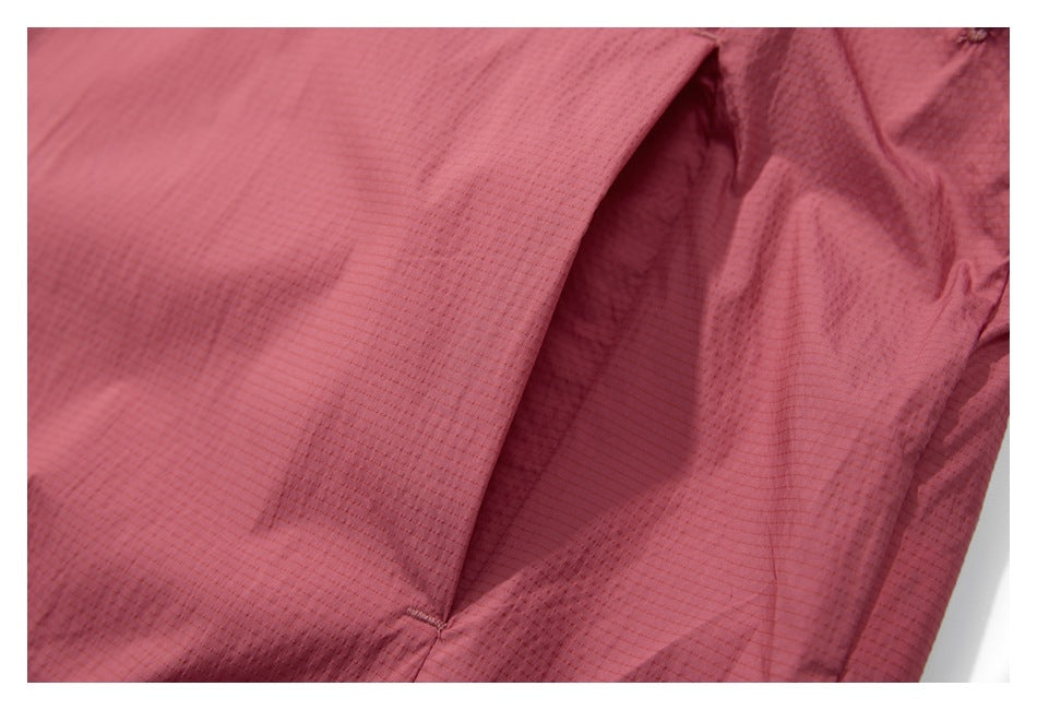Close-up of the dusty rose jacket's textured fabric and a curved seam.