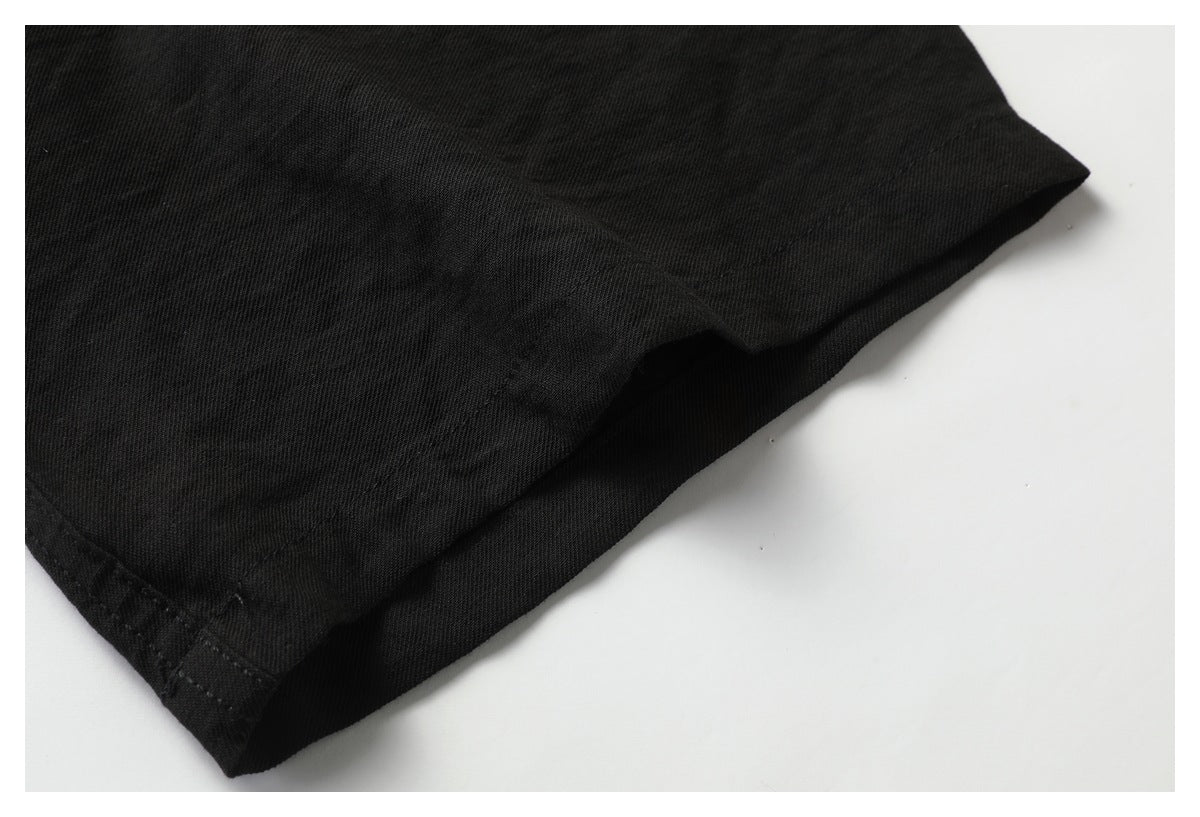 Close-up of the stitched hem on a black shirt.