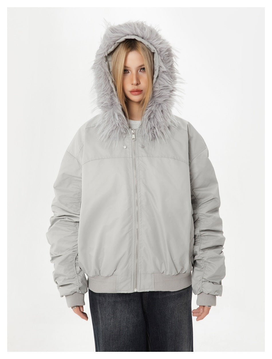 Model wearing a light gray zip-up jacket with a fur-trimmed hood and ribbed cuffs and hem.