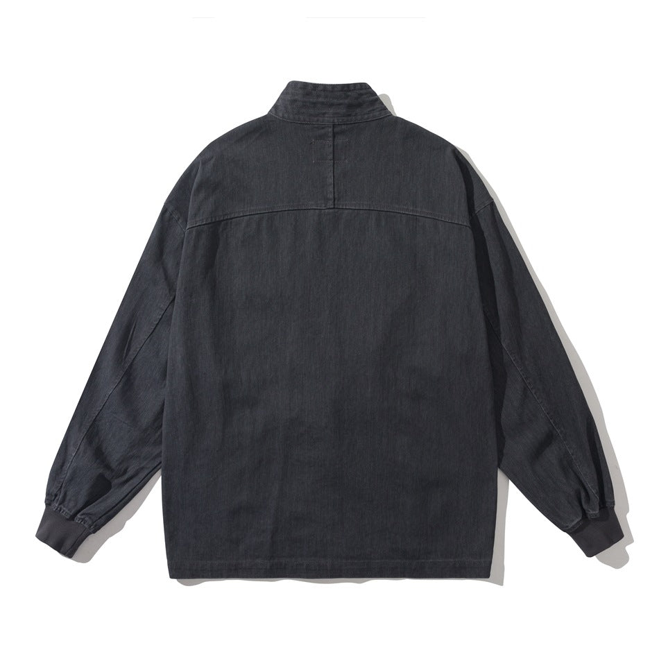Back view of black jacket with stand-up collar, back yoke seam, drop shoulders and ribbed cuffs