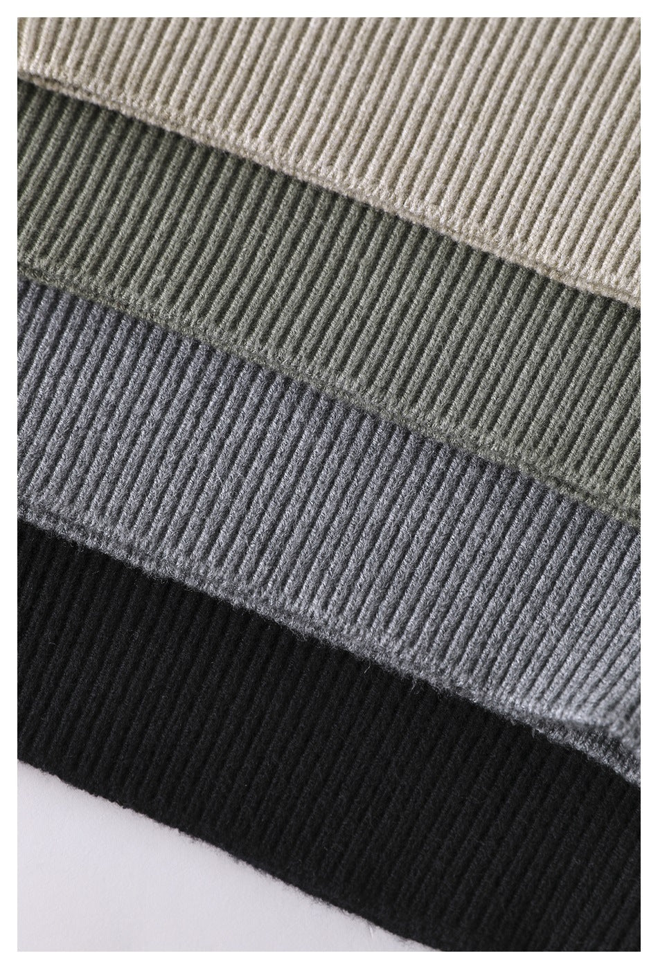 Close-up of ribbed knit fabric in cream, olive gray, heather gray, and black bands.