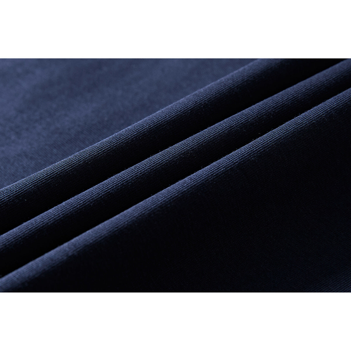 Close-up of navy fabric folded to show its surface and texture.