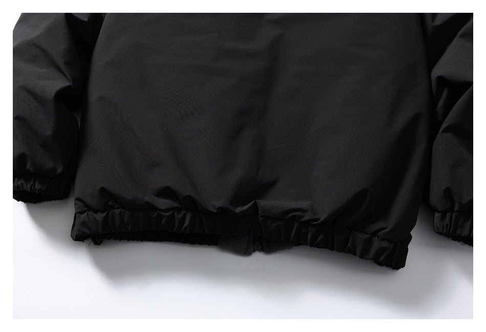 Close-up of a black jacket's gathered elastic hem and sleeve cuffs.
