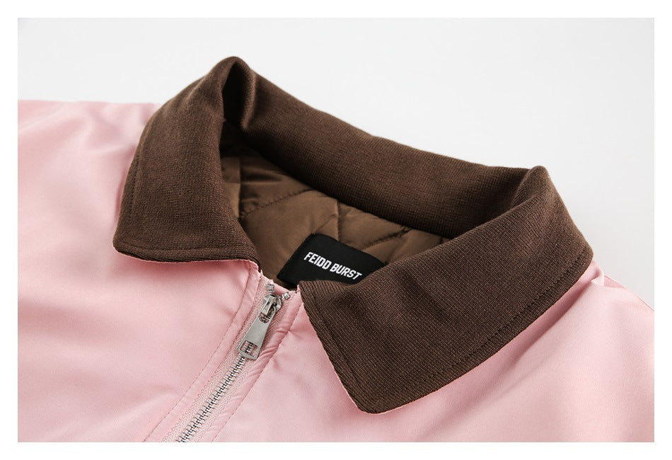 Close-up of the jacket’s brown ribbed collar, quilted lining, pink fabric, zipper, and sewn-in label.
