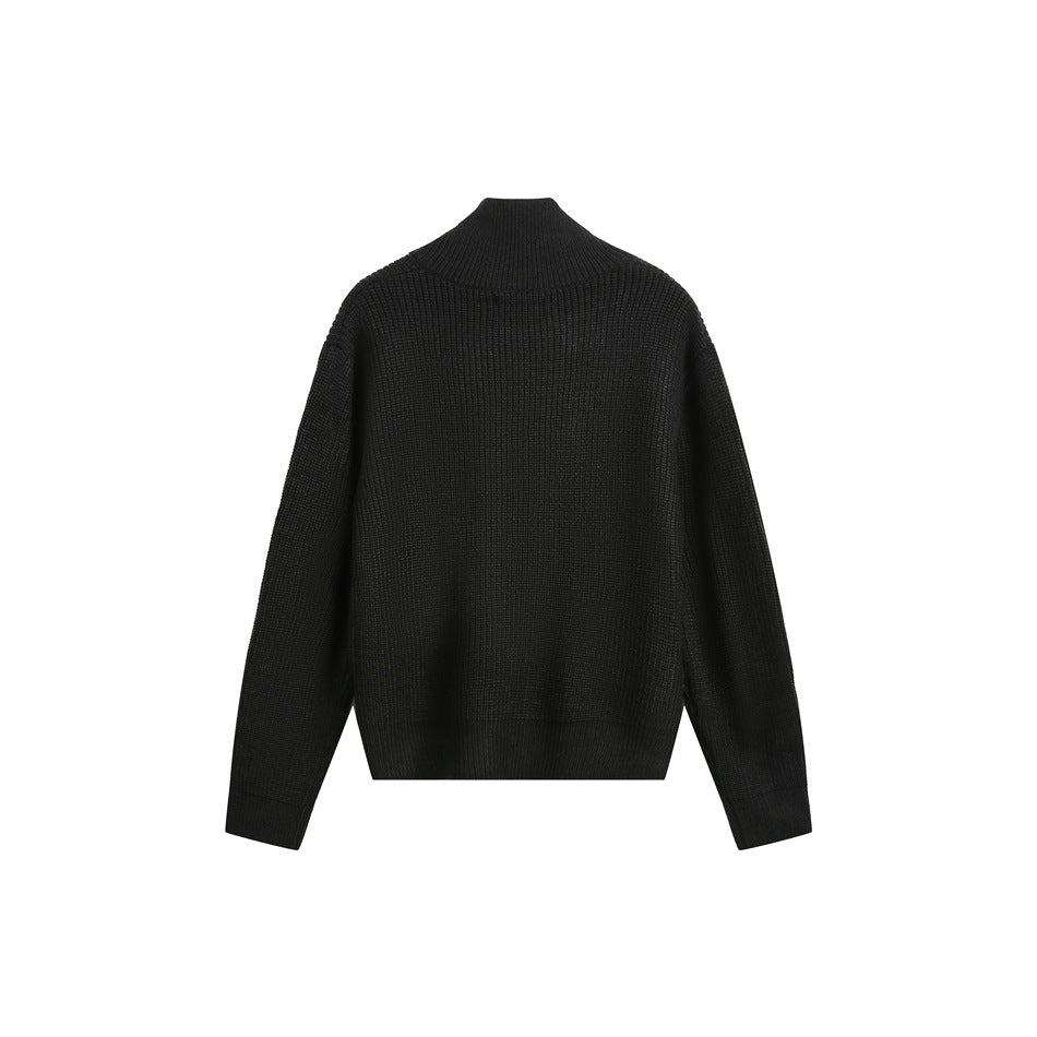 Back view of a dark ribbed zip-front sweater with a high stand collar and long sleeves.