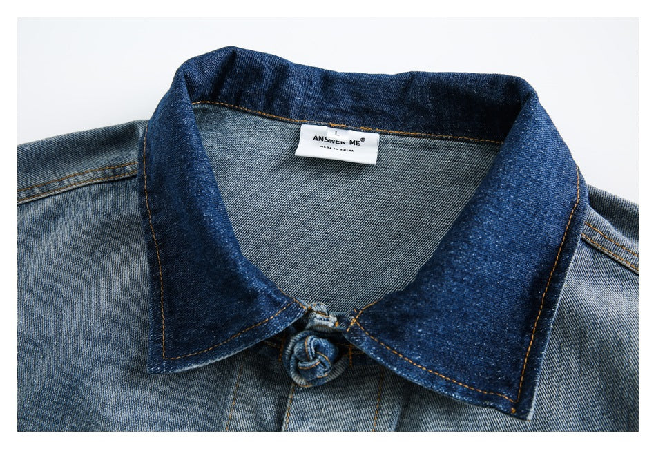Close-up of the jacket's dark denim collar, knotted closure, contrast stitching, and English brand label.