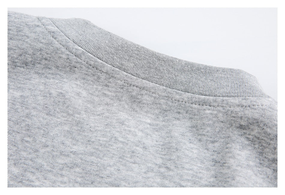 Close-up of a ribbed neckline on light gray marled knit fabric.