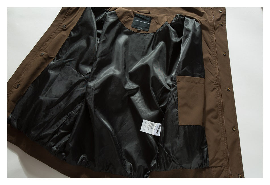 Brown jacket opened flat to show its shiny black lining, inner pocket, and labels.