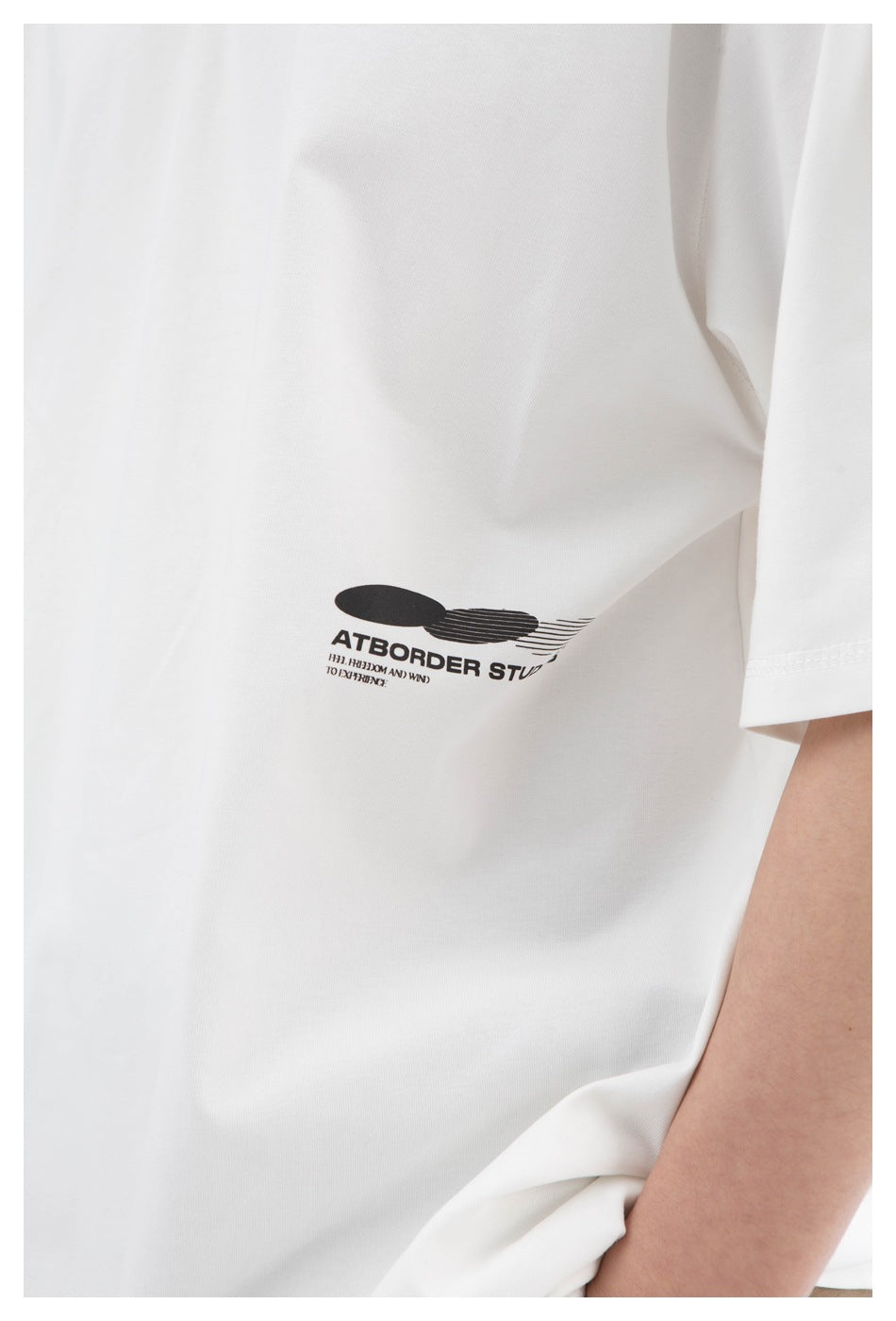 Close-up of a black graphic and English text printed on a white T-shirt.