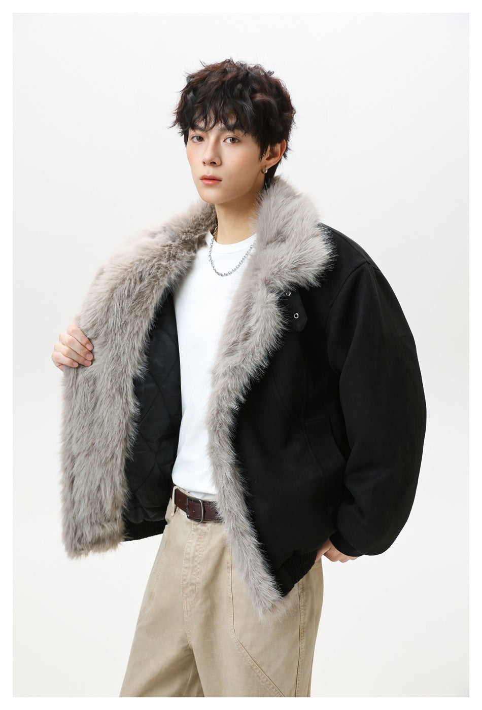 Model wearing a black jacket with a wide gray faux-fur collar and open front.
