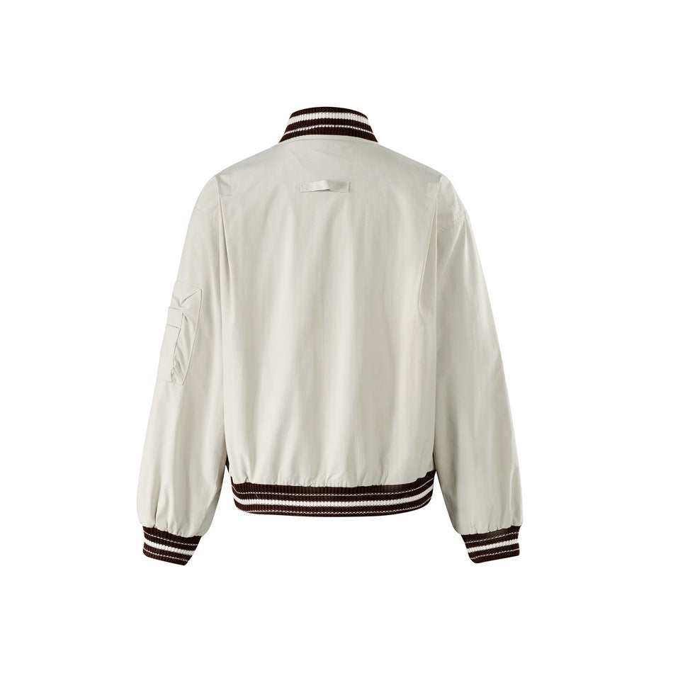 Back view of a light beige jacket with a striped brown-and-cream collar, cuffs, and waistband.