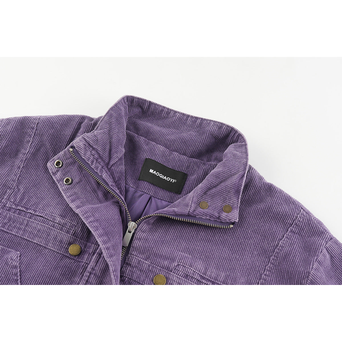 Close-up of a purple corduroy jacket collar, zipper, brass snaps, and inner neck label.