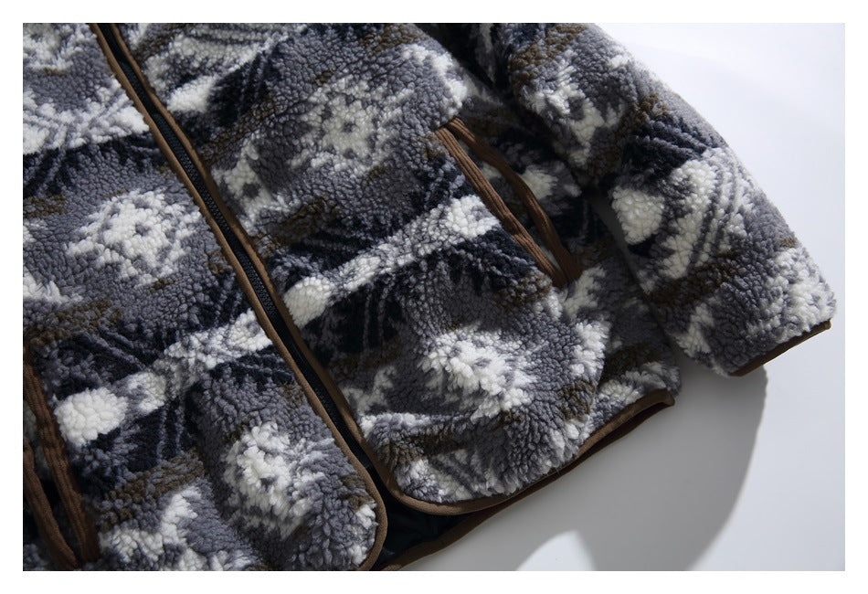Partial view of a patterned fleece jacket showing its front zipper, brown-trimmed pocket, sleeve, and hem.